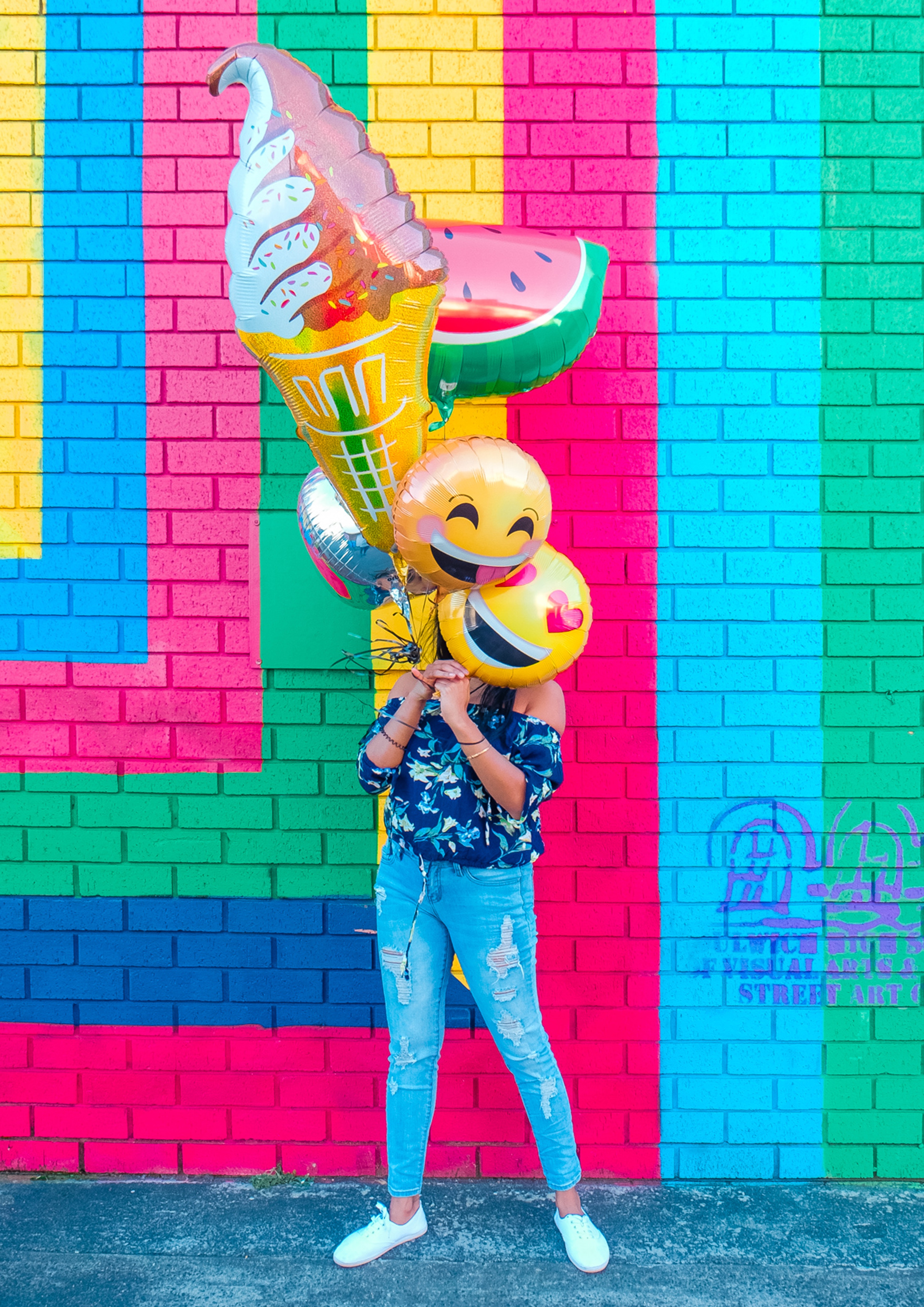 woman with emoji balloons