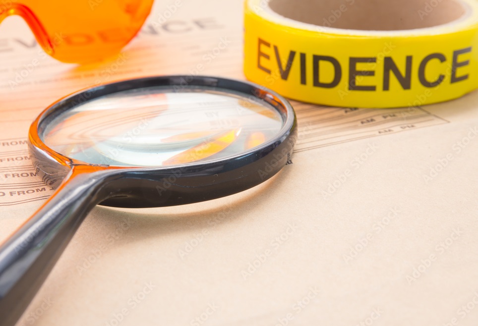 goggles, magnifying glass and evidence tape on a envelope