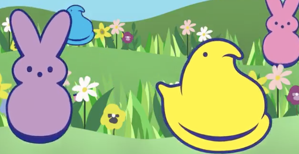 purple and pink bunny and yellow and blue marshmallow candy in hills of grass with flowers