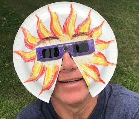 Man with Solar Eclipse glasses holder