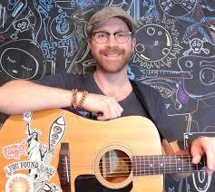 Image of musician Mark DeRose with his acoustic guitar.