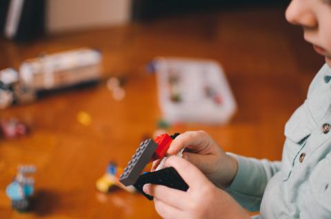 child playing with lego toys