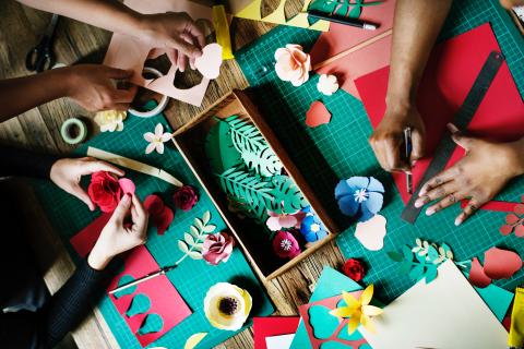 hands crafting with colored paper