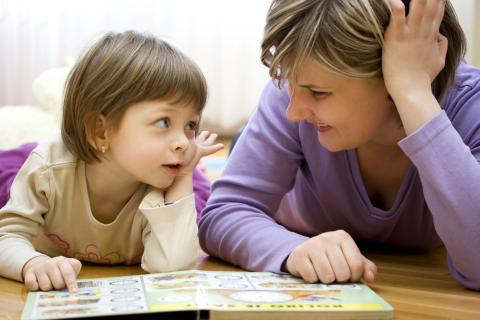 image of a child reading with an adult